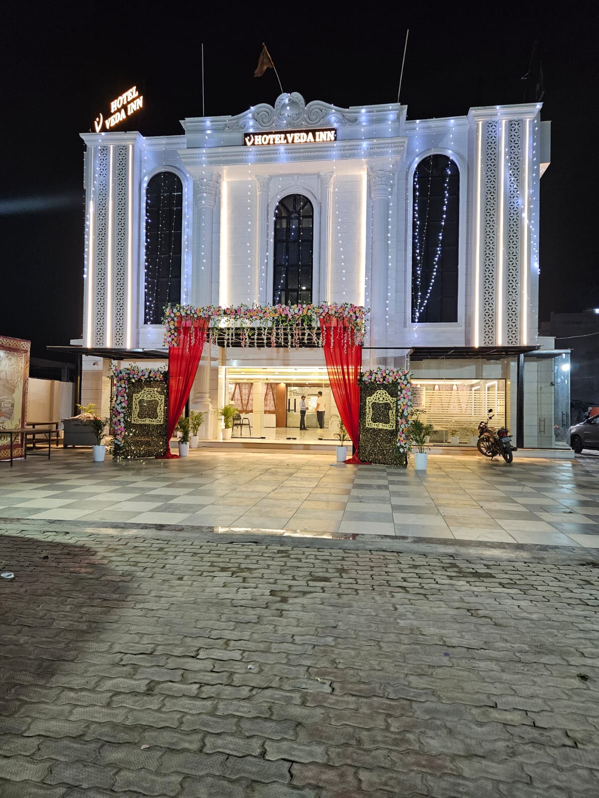 Hotel Veda Inn exterior glowing at night