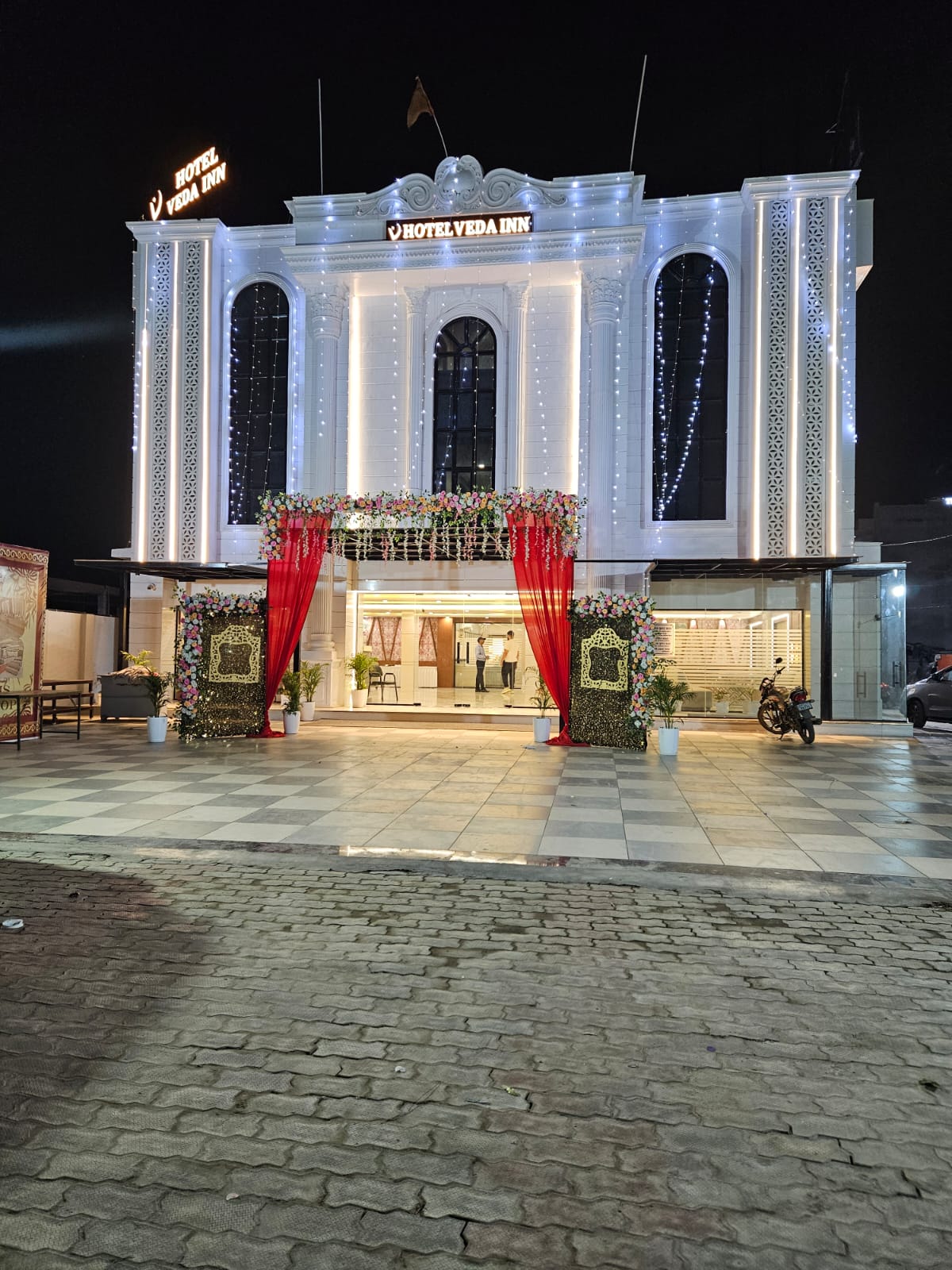 Illuminated hotel facade after dark