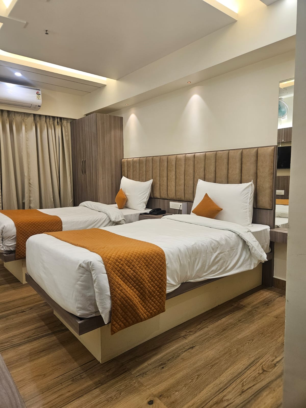 Deluxe Room at Hotel Veda Inn with double bed and warm lighting