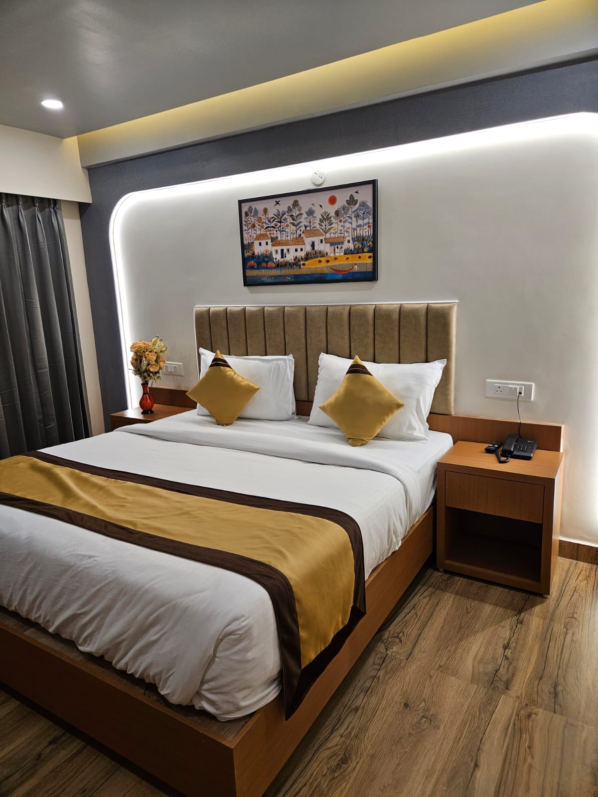 Neatly made-up bed in a Veda Inn guest room